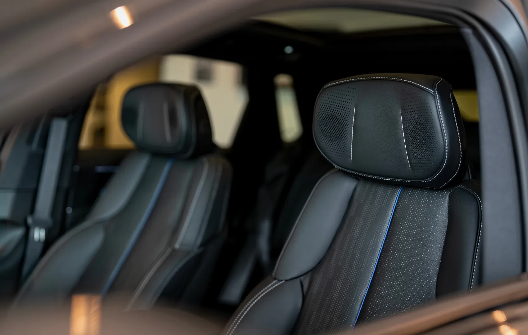 Benefits of leasing a car - car interior inside of a dealership showroom