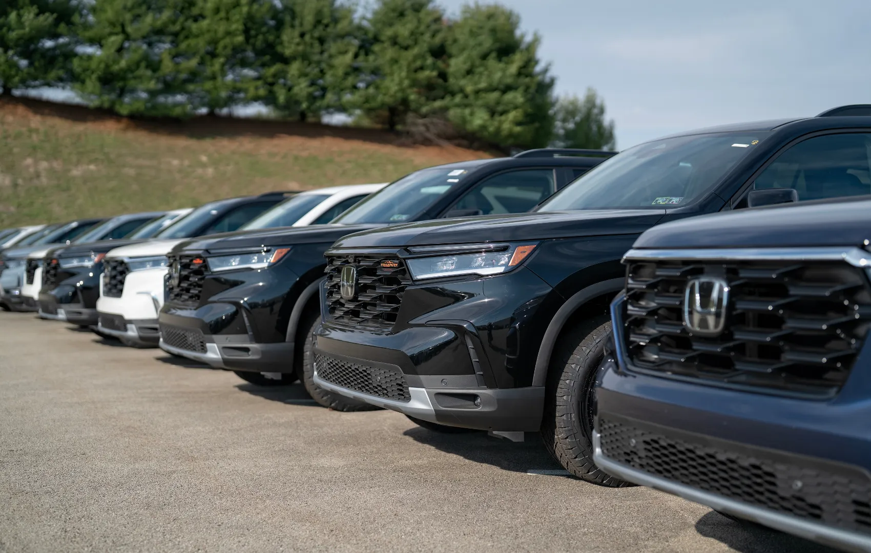 Buying vs. leasing a car - Honda vehicles lined up in C. Harper parking lot
