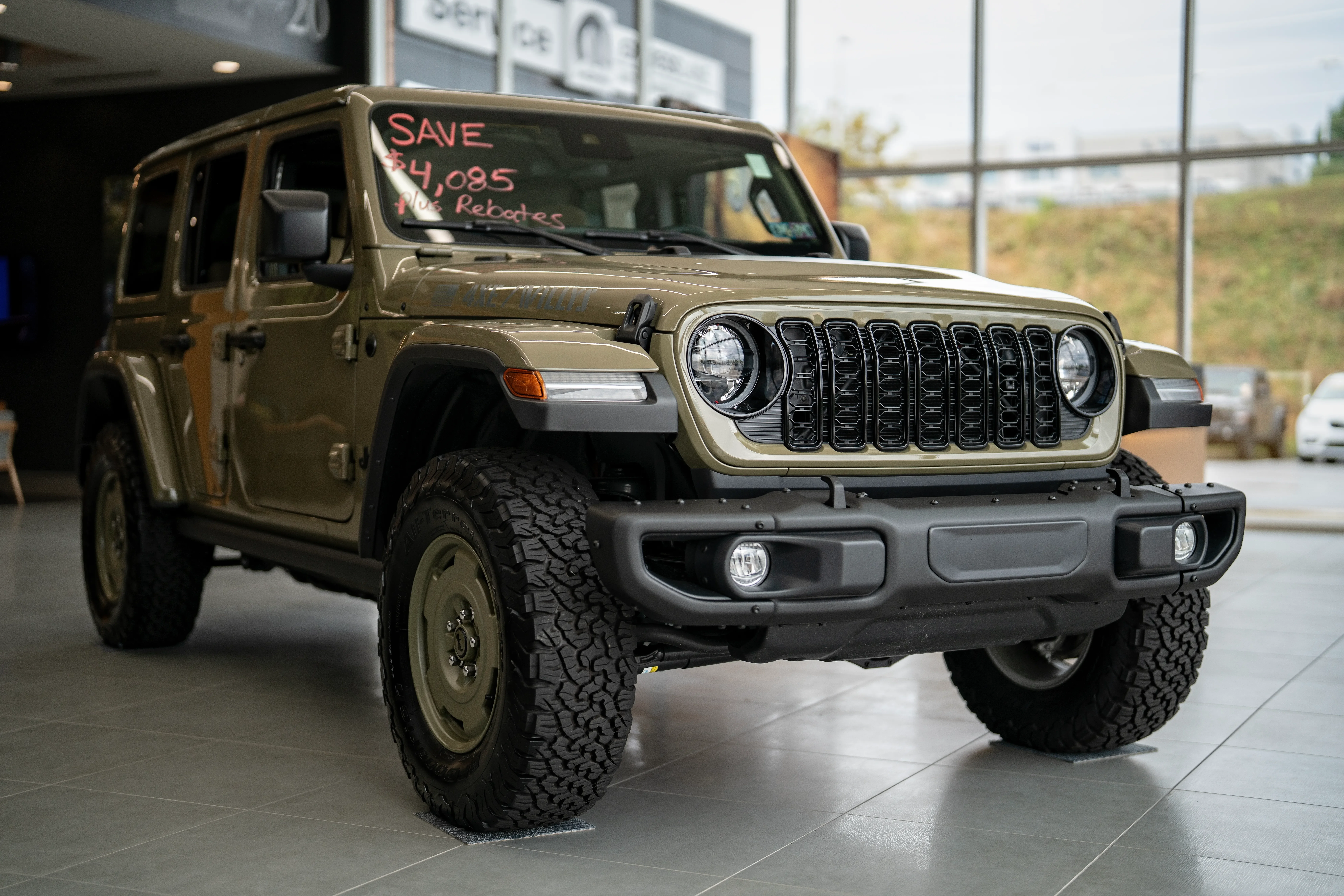 What are the C. Harper Pre-Owned Classification Tiers? Army green Jeep Wrangler in C. Harper showroom
