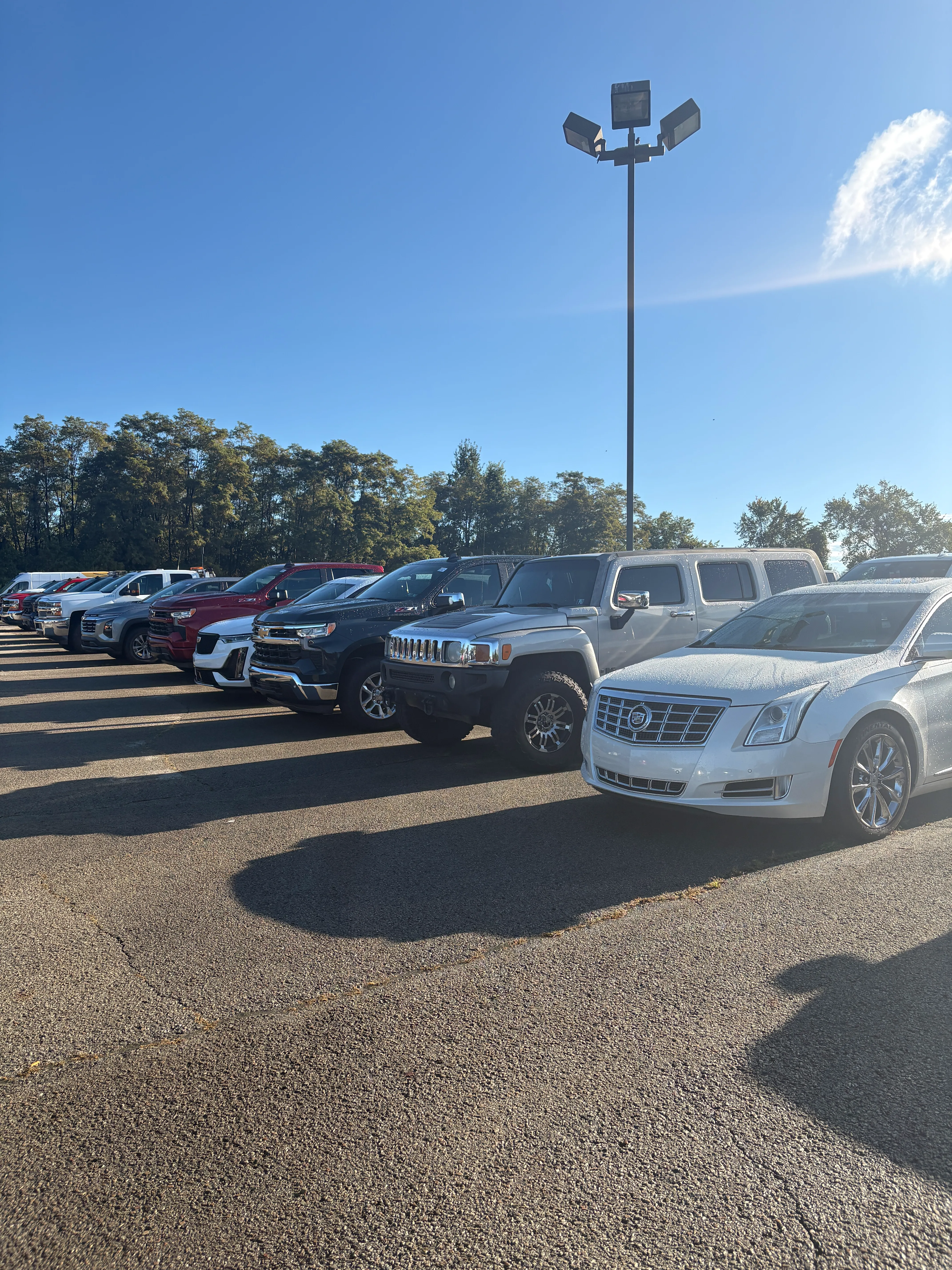 Used cars and pre-owned vehicles parked in C. Harper parking lot